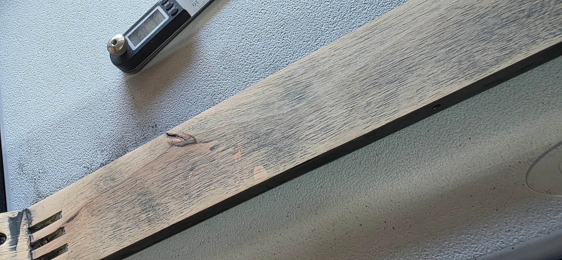 Close-up of the snapped wooden support member that left a nearly new bench unstable.