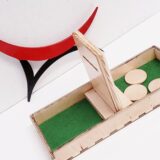 Montessori object permanence board with coins and tray